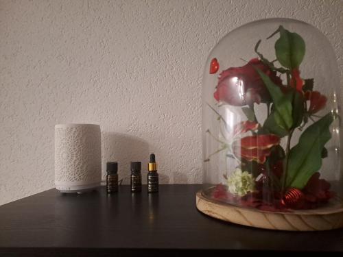 a table with a vase with flowers and a candle at Vacances en tout tranquillité à Vercorin in Vercorin