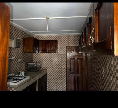 a kitchen with a stove and a stove top oven at Dutchlond Rooms in Freetown