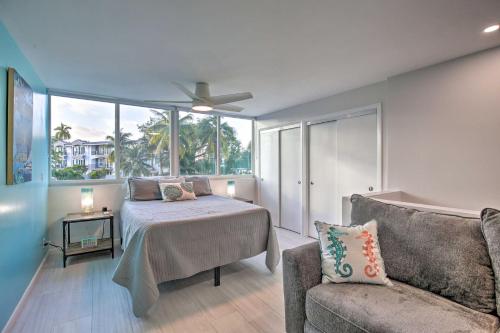 a living room with a bed and a couch at Canal-Front Condo Walk to Downtown Ft Lauderdale! in Fort Lauderdale