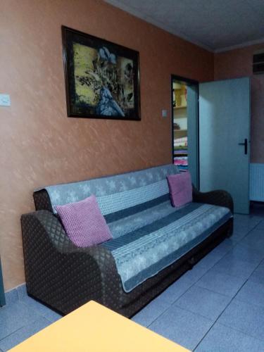 a couch with two pillows on it in a room at Prenociste DUGA in Užice