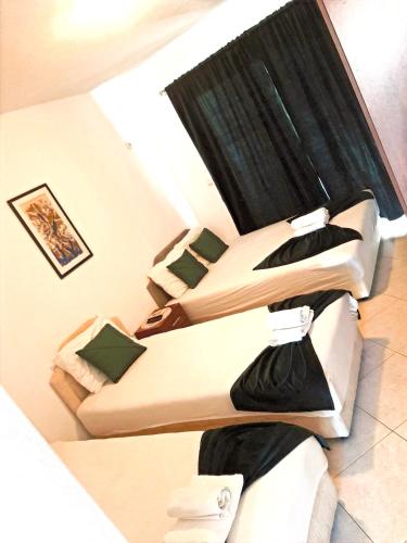 a room with two beds in a room at Villa Alba Apartments in Dobra Voda