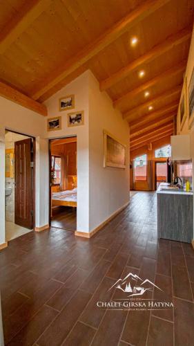 a large living room with a wooden ceiling at Apartments Chalet Girska Hatyna in Vorokhta