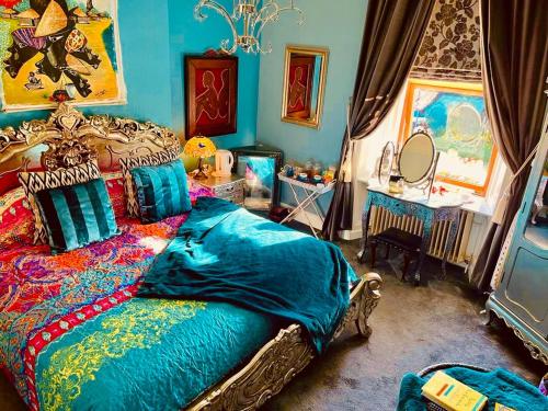 a bedroom with a bed and a mirror at Belmont House Boutique - the Kingsley collection in Berwick-Upon-Tweed