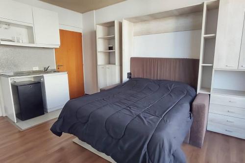 a bedroom with a bed and a kitchen at AT803 - Monoambiente Luminoso en Colegiales in Buenos Aires