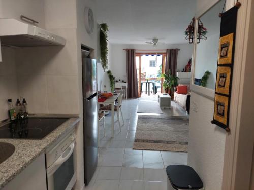 a kitchen with a refrigerator and a dining room at Pool & View Christianos in Los Cristianos