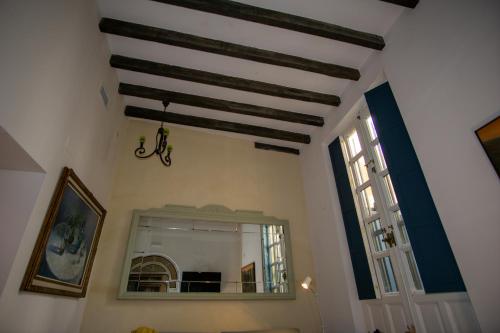 a room with a mirror and a window at Apartamentos Sharis in Jerez de la Frontera