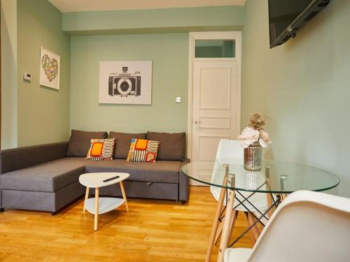 a living room with a couch and a glass table at (Oxford Street - Piccadilly Circus) Apartment Central London in London