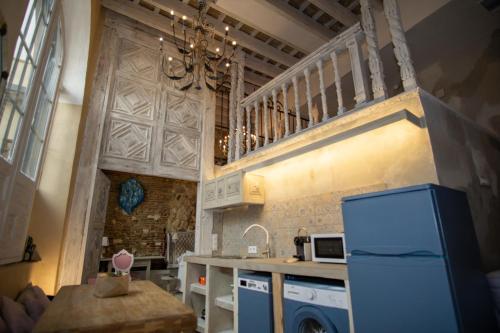 a kitchen with a blue refrigerator and a sink at Apartamentos Sharis in Jerez de la Frontera