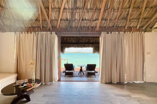 a living room with a view of the ocean at Akalki Hotel y Centro Holistico in Bacalar
