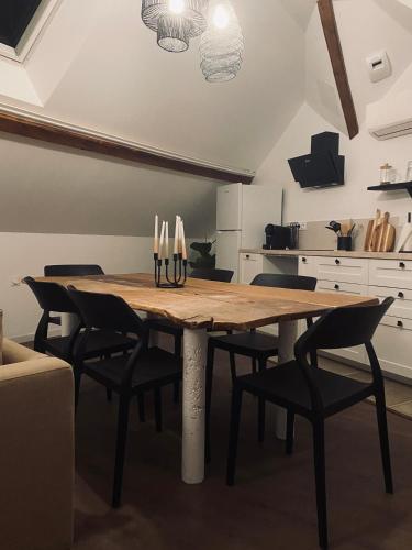 a dining room with a wooden table and chairs at T3 Kokon Lumineux & Chaleureux, Parking, Climatisation in Bagnères-de-Bigorre