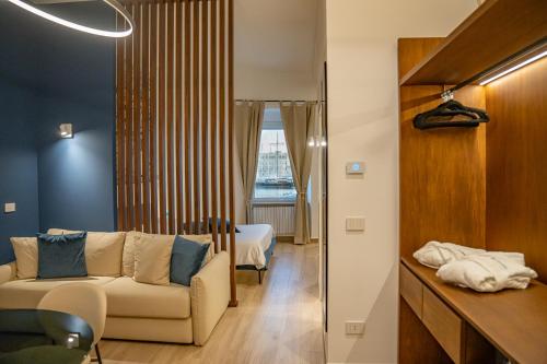 a living room with a couch and a bedroom at LA BANCHINA LUXURY SUITES in Trani