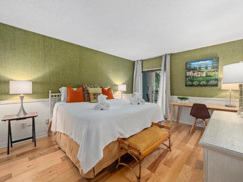 a bedroom with a large bed and a table and chairs at Ocean One 222 in Hilton Head Island