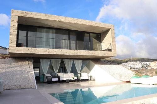 un edificio con piscina e una casa di Amazing Villa in Benalmadena a Benalmádena