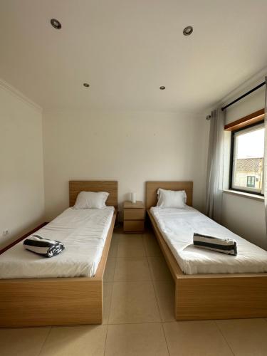 duas camas sentadas uma ao lado da outra num quarto em Ocean Guesthouse Baleal em Ferrel