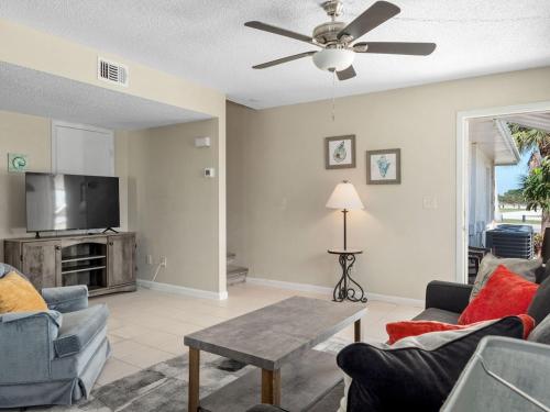 a living room with a couch and a tv at Townhouse Apartment b in Fort Pierce