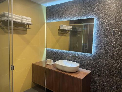 a bathroom with a sink and a mirror at Luxurious sunlit maisonette with large terrace! in Marsaskala