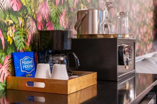 a coffee machine sitting on a counter next to a counter top at Whitelaw Hotel in Miami Beach