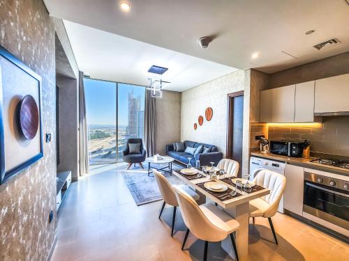 a kitchen and dining room with a table and chairs at STAY BY LATINEM Luxury 2BR Holiday Home CV B1614 near Burj Khalifa in Dubai