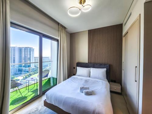 a bedroom with a large bed and a large window at STAY BY LATINEM Luxury 2BR Holiday Home CV B1614 near Burj Khalifa in Dubai