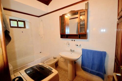 a bathroom with a sink and a toilet and a mirror at La Herbilla in Garafía