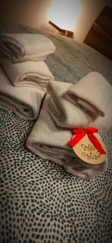 a pile of towels sitting on top of a bed at Kemilia Matera in Matera