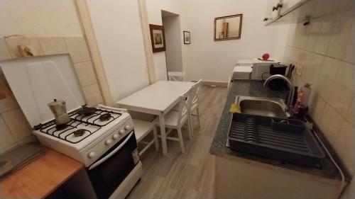 a small kitchen with a stove and a sink at Retro Rooms in Budapest