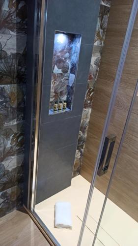 a glass door with a mirror in a bathroom at Kemilia Matera in Matera