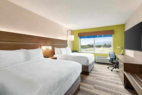 a hotel room with two beds and a window at Holiday Inn Express & Suites - Ukiah by IHG in Ukiah