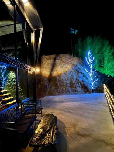 a stage with christmas lights on a stone wall at Gzaze in Stepantsminda