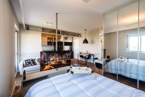 a bedroom with a bed and a fireplace in it at Loft Luxo Morumbi, WIFI500MB - Traveller Awards 2024 in Sao Paulo