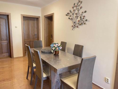a dining room with a table and chairs at Chalupa pod Tatrami in Liptovská Teplička