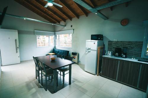 a kitchen with a table and a refrigerator at brisas de villa gesell in Villa Gesell