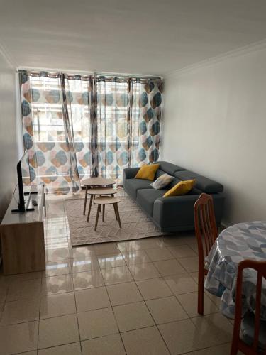 uma sala de estar com um sofá e uma mesa em Appartement Cosy Pointe-à-Pitre em Pointe-à-Pitre