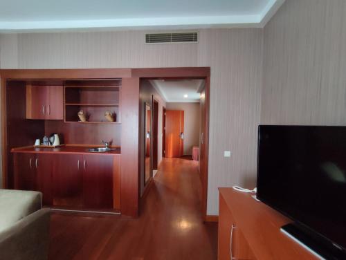 a living room with a flat screen tv in a room at The Green Park Bostancı in Istanbul