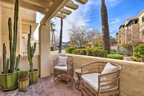a patio with two chairs and cactus at Scottsdale Condo with Pool Access, Near Old Town! in Scottsdale