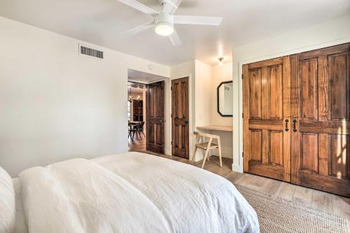 a white bedroom with a bed and a ceiling fan at Scottsdale Condo with Pool Access, Near Old Town! in Scottsdale