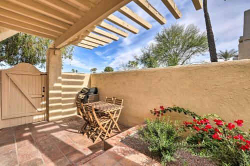 a patio with a table and a fence at Scottsdale Condo with Pool Access, Near Old Town! in Scottsdale
