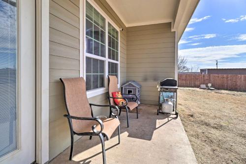 two chairs sitting on a porch with a grill at China Spring Home about 13 Mi to Downtown Waco! in China Springs