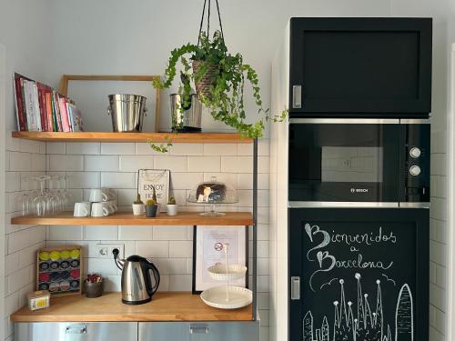 a kitchen with a black refrigerator and a counter at Charming appartement in the heart of Barcelona in Barcelona