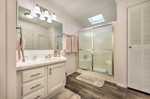 a bathroom with a shower and a sink and a mirror at Charming South Haven Home - Great Location! in South Haven