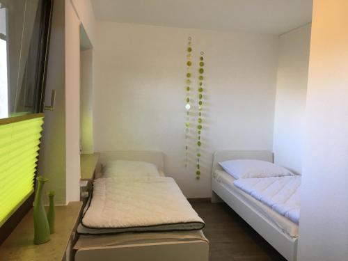 a room with two beds in it with green accents at Emotion zentrumsnah für bis zu 6 Personen in Winterberg