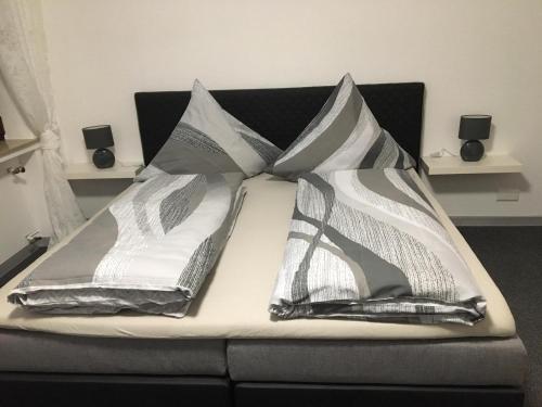 a bed with three pillows on top of it at Emotion zentrumsnah für bis zu 6 Personen in Winterberg