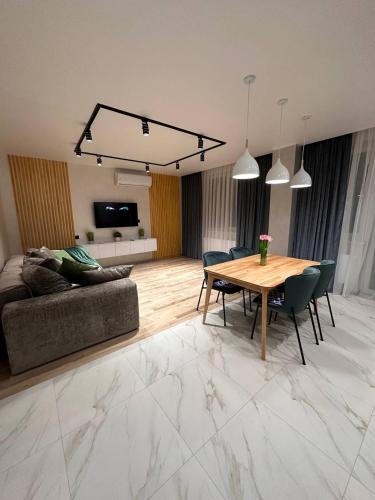 a living room with a table and a couch at ВІП стилізовані у Львові з просторою вітальнею, на вулиці Під Голоском 15 Б in Lviv