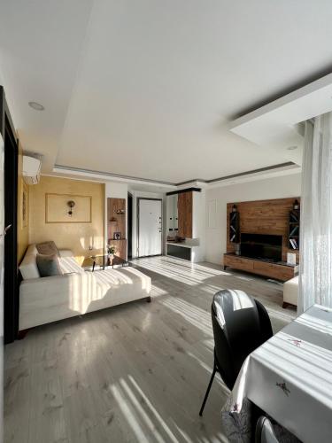 a large bedroom with a bed and a table and chairs at ONLY ONE Suites & Residences in Antalya