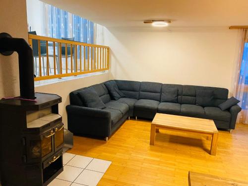 a living room with a couch and a stove at Lake View Residence in Niederried