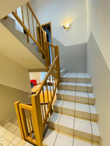 a staircase in a house with wooden rails at Lake View Residence in Niederried