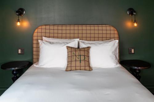 a bedroom with a bed with white sheets and pillows at NP Boutique Lodge in Big Bear Lake