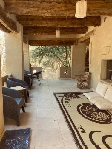 a living room with a couch and a fireplace at Siwa Desert Home in ‘Izbat Ţanāţī