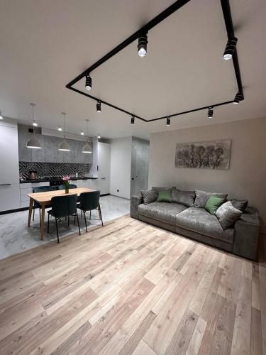 a living room with a couch and a table at ВІП стилізовані у Львові з просторою вітальнею, на вулиці Під Голоском 15 Б in Lviv
