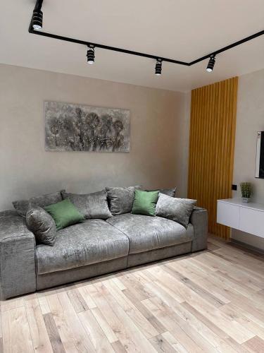 a living room with a gray couch in a room at ВІП стилізовані у Львові з просторою вітальнею, на вулиці Під Голоском 15 Б in Lviv
